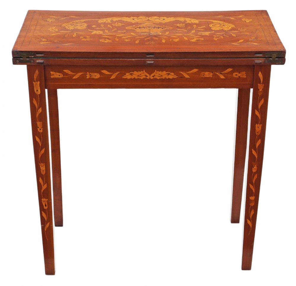 A Victorian mahogany fold-over card table decorated with central urn floral marquetry inlays on the top and tapered legs. View VIII