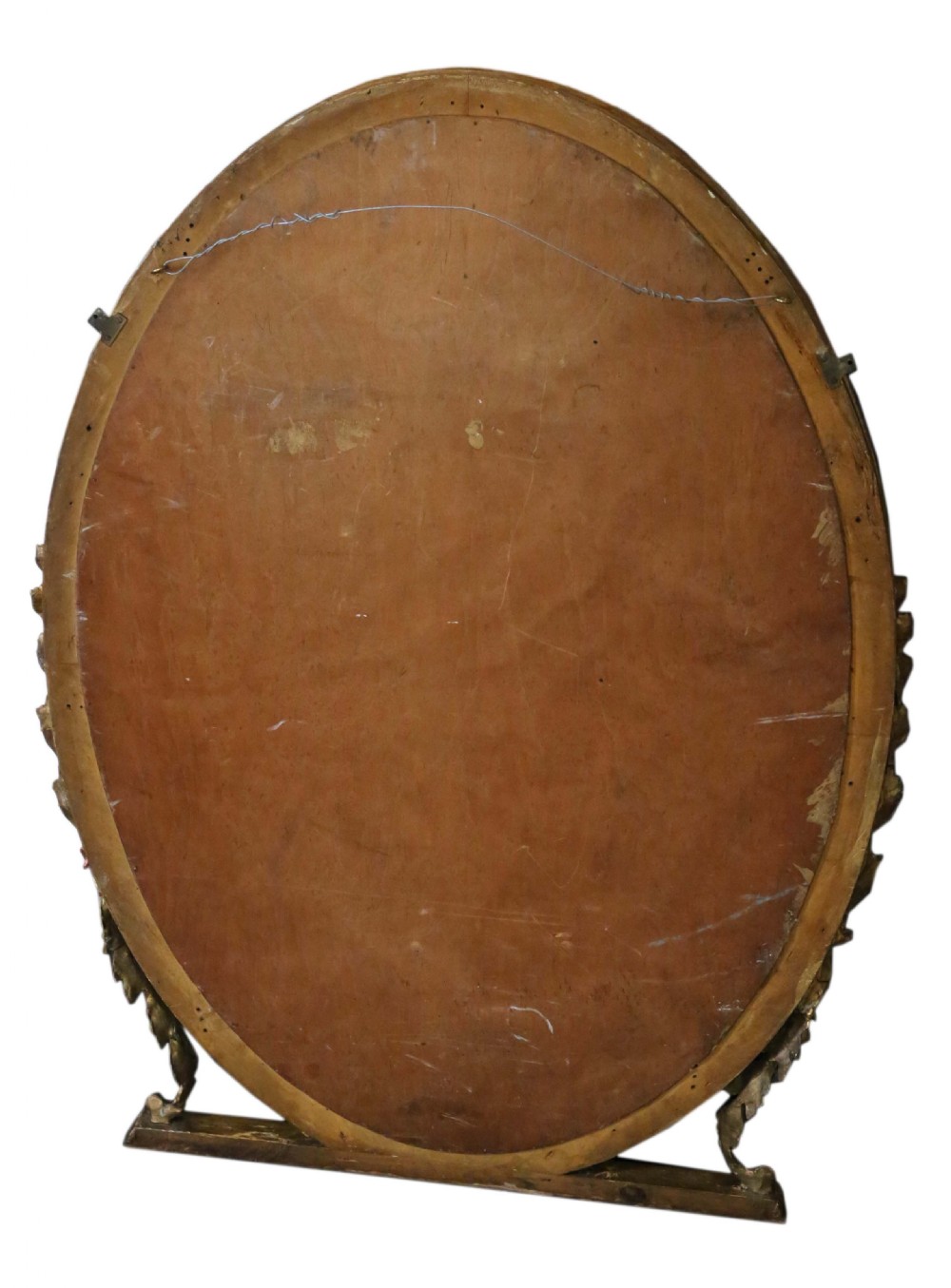 An antique gold gilt oval wall mirror featuring a Neoclassical ribbon motif at the base and foliage side supports. View VII