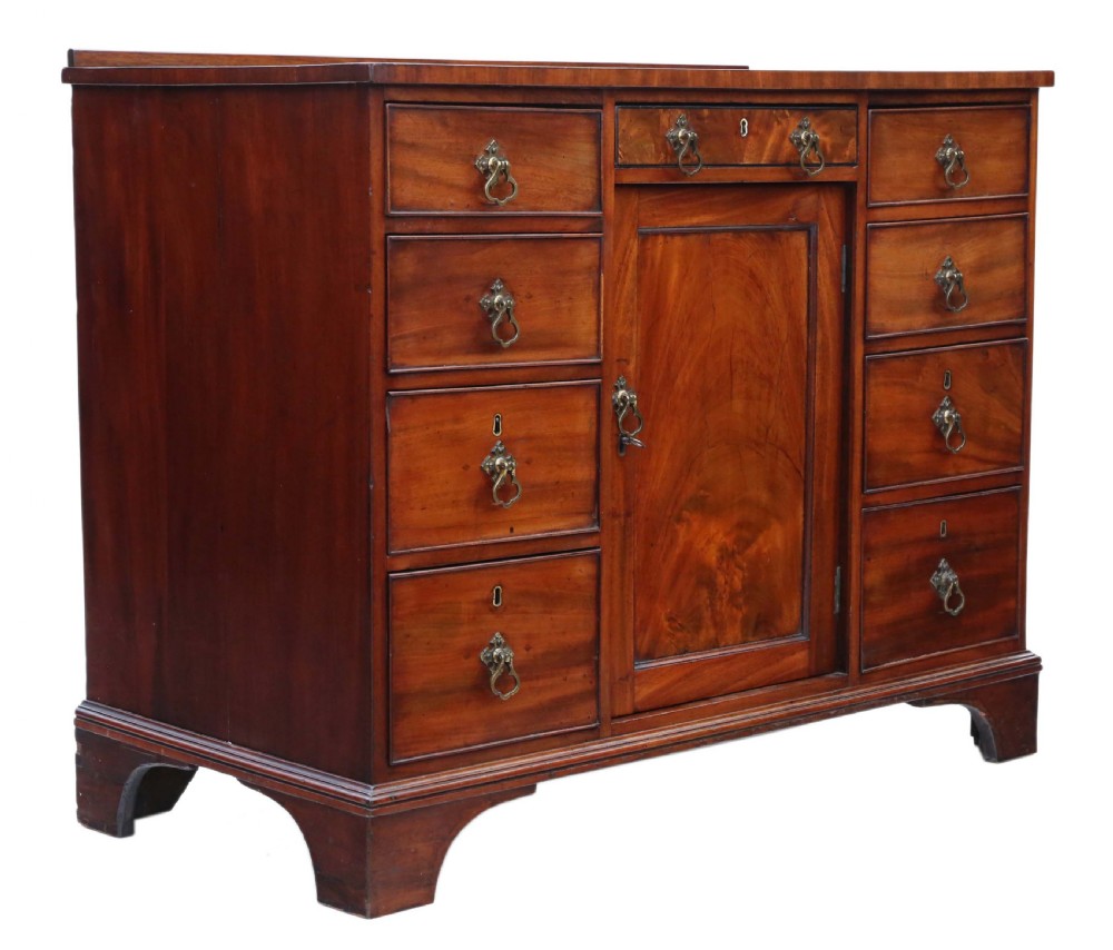 A late Georgian mahogany kneehole desk circa 1820 featuring a central recessed cupboard, eight side drawers with brass swing handles, and bracket feet. View VIII