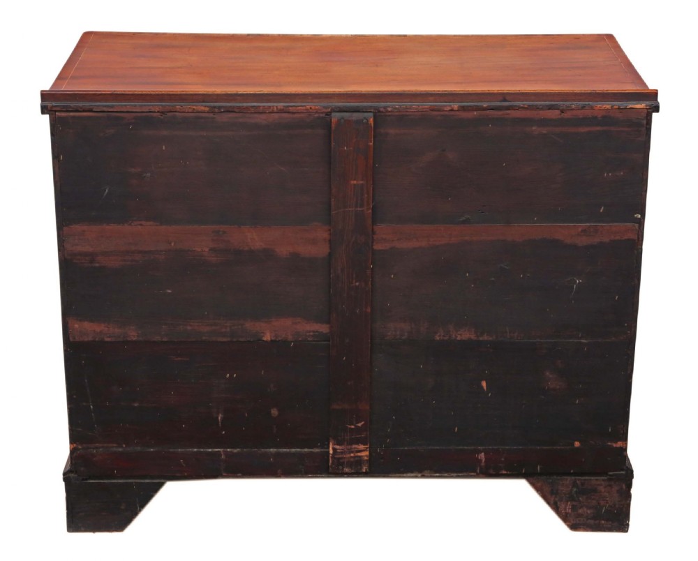 A late Georgian mahogany kneehole desk circa 1820 featuring a central recessed cupboard, eight side drawers with brass swing handles, and bracket feet. View IX