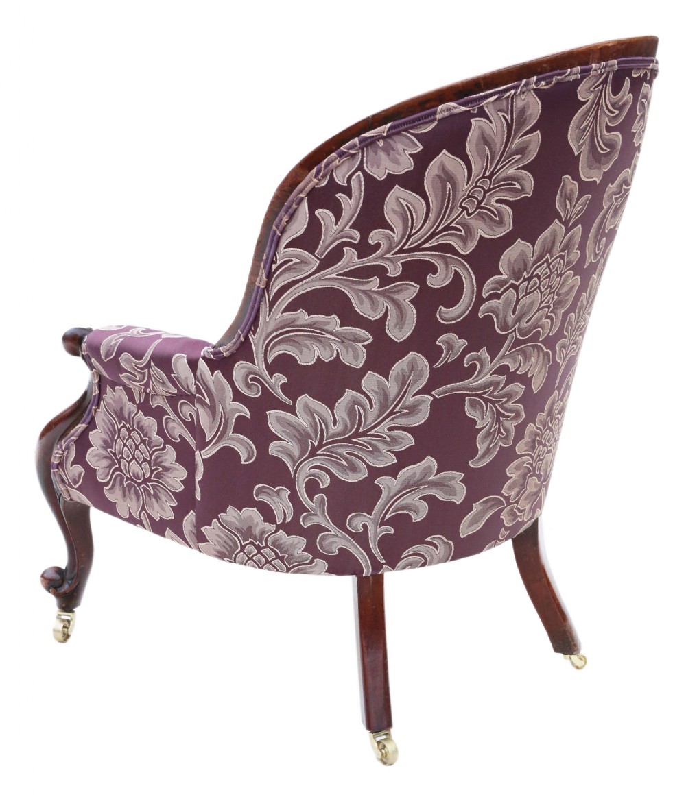 A Victorian mahogany spoon back armchair upholstered in deep purple damask fabric with deep buttoning and cabriole legs. View III
