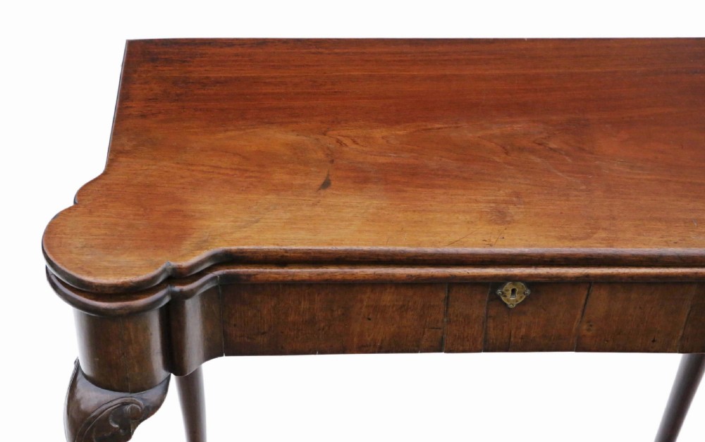 A Georgian mahogany folding card table featuring a shaped serpentine top, a single brass keyhole escutcheon, and four slender cabriole legs ending in pad feet. View III
