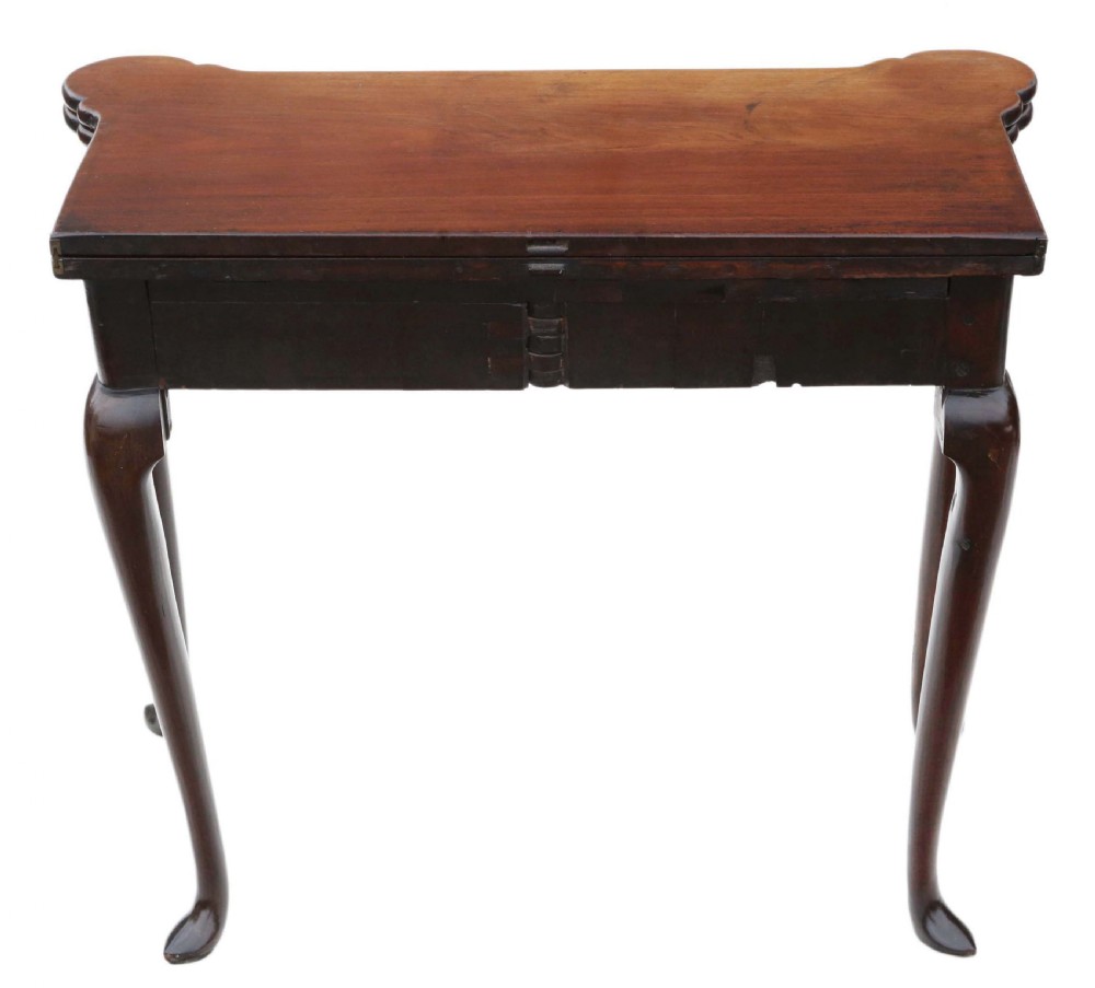 A Georgian mahogany folding card table featuring a shaped serpentine top, a single brass keyhole escutcheon, and four slender cabriole legs ending in pad feet. View X
