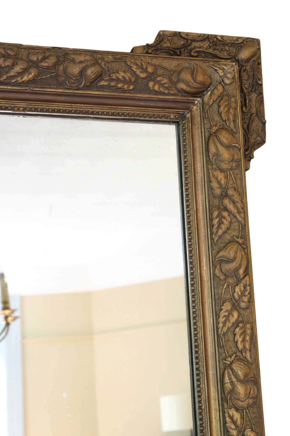 A large rectangular 19th-century giltwood mirror with foliate relief mouldings and corner ear projections. View III