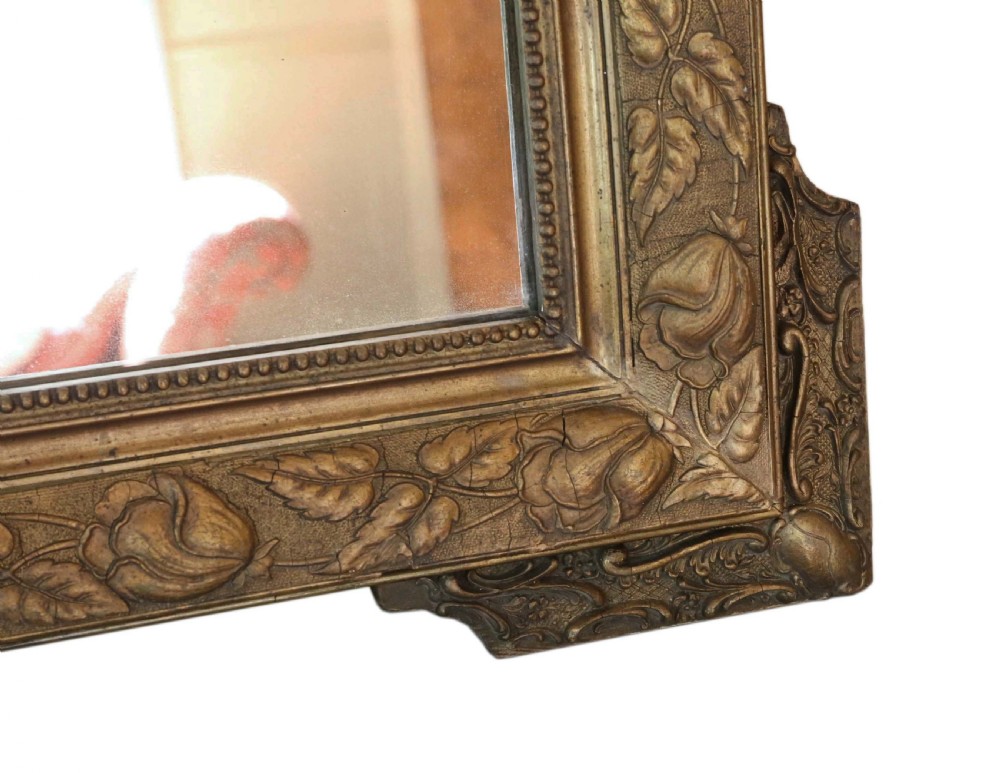 A large rectangular 19th-century giltwood mirror with foliate relief mouldings and corner ear projections. View IV
