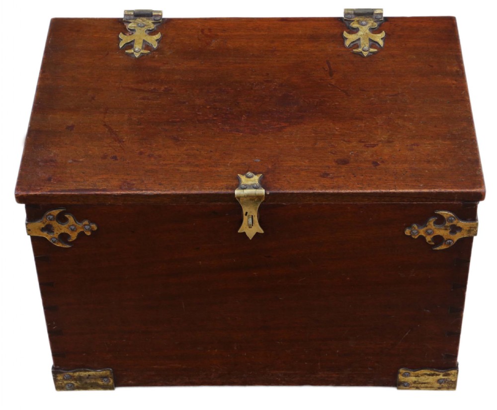 A rectangular mahogany wooden box featuring decorative brass corner mounts, top strap hinges, and a central brass clasp mechanism.
