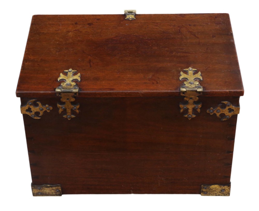 A rectangular mahogany wooden box featuring decorative brass corner mounts, top strap hinges, and a central brass clasp mechanism. View V
