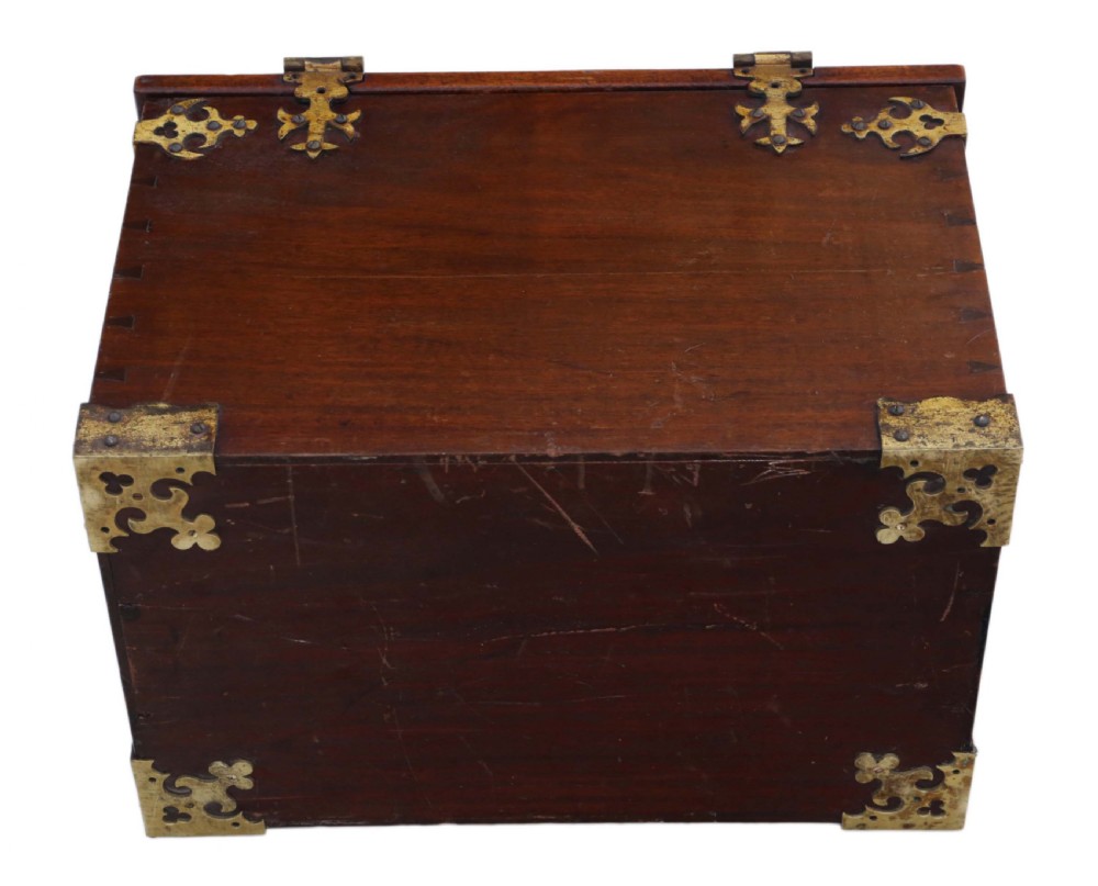 A rectangular mahogany wooden box featuring decorative brass corner mounts, top strap hinges, and a central brass clasp mechanism. View VII
