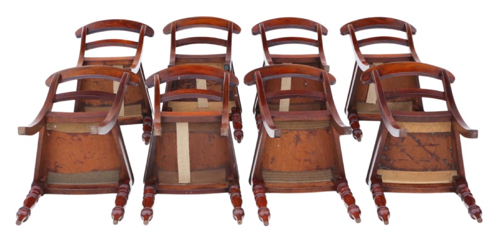 A matched set of eight antique Victorian mahogany dining chairs featuring curved top rails, solid wood seats, and turned front legs. View III