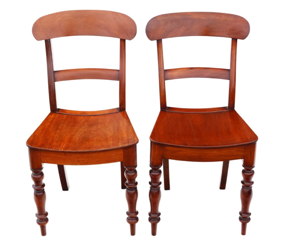 A matched set of eight antique Victorian mahogany dining chairs featuring curved top rails, solid wood seats, and turned front legs. View IV