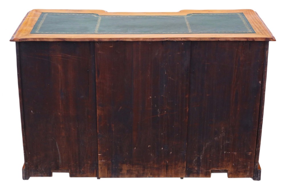 A Victorian satin walnut pedestal desk featuring a green gilt-tooled leather writing surface, multiple drawers with drop ring handles, and a central cupboard door. View X