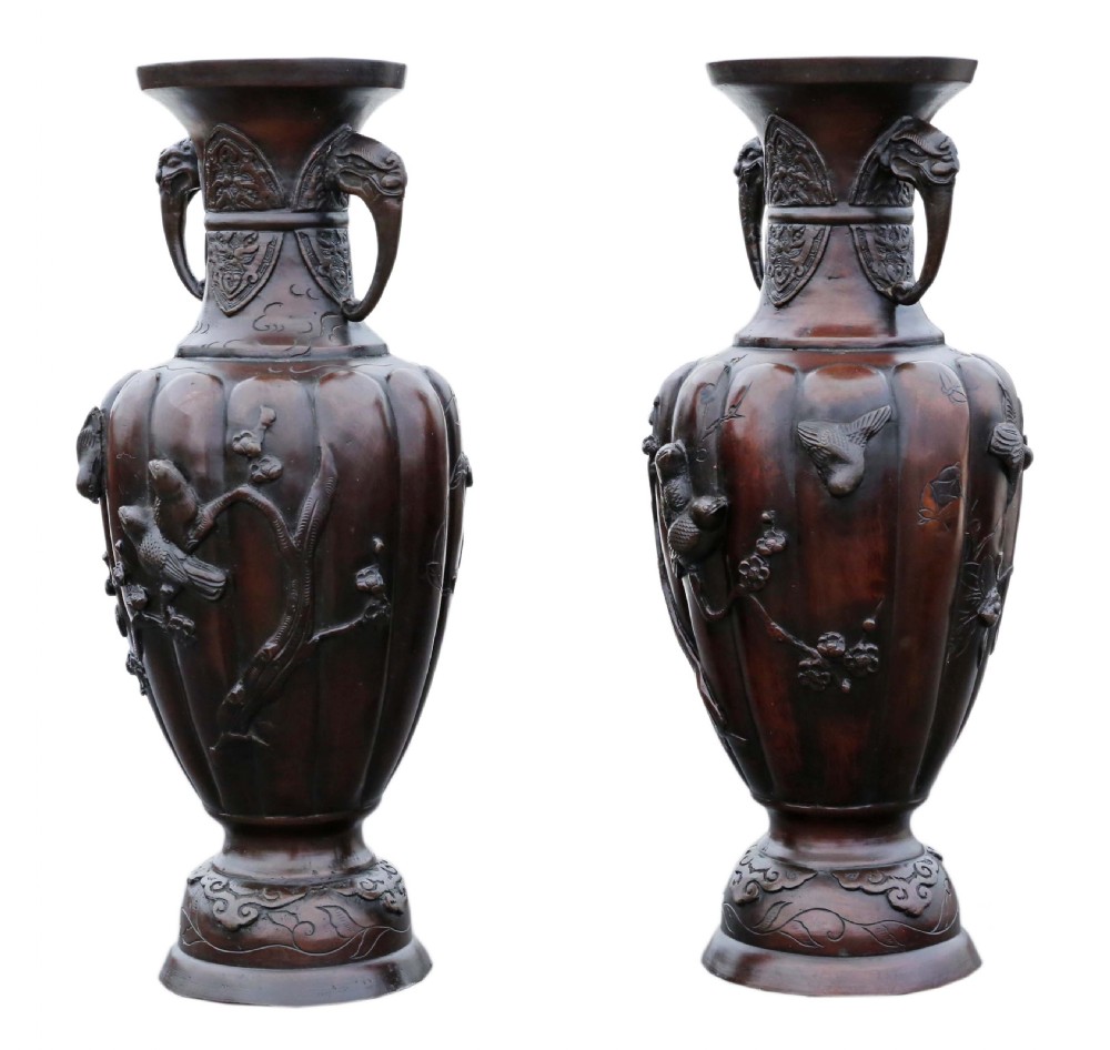 A pair of dark patinated bronze baluster vases featuring relief carvings of birds on branches and elephant head handles. View III