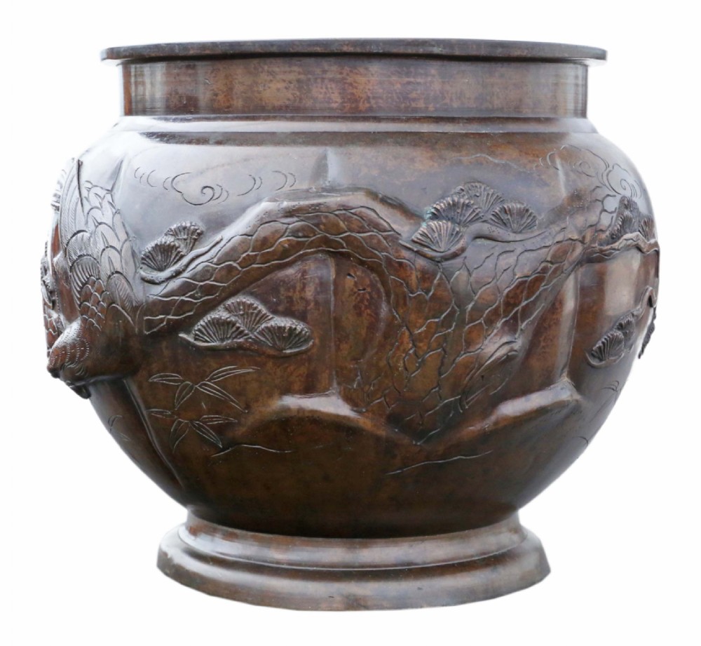 A Japanese Meiji period cast bronze jardiniere featuring a lobed body and high-relief carved decoration depicting birds amongst pine branches. View II