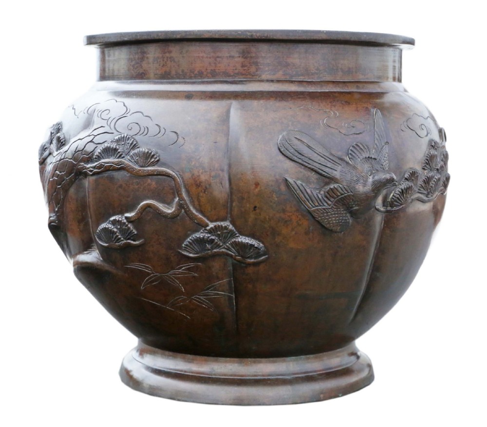 A Japanese Meiji period cast bronze jardiniere featuring a lobed body and high-relief carved decoration depicting birds amongst pine branches. View III
