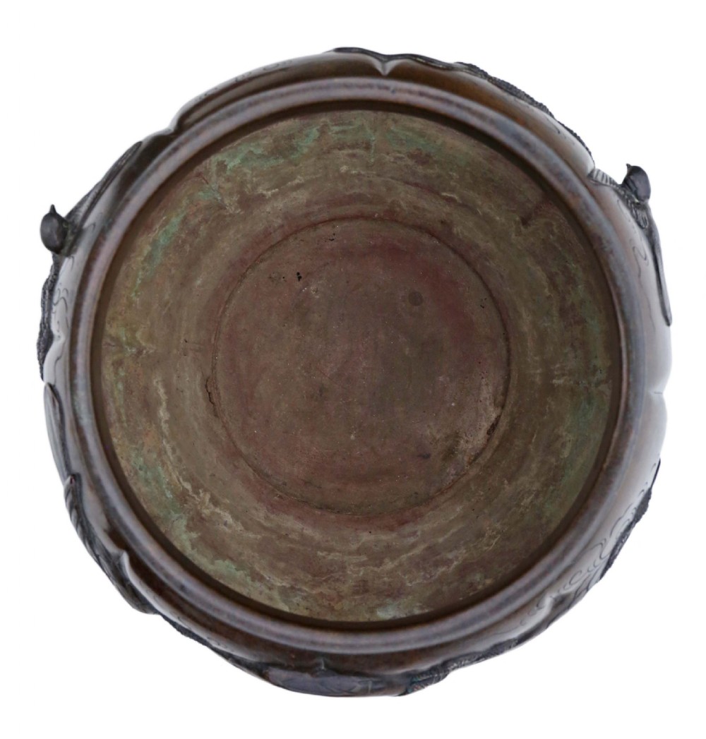 A Japanese Meiji period cast bronze jardiniere featuring a lobed body and high-relief carved decoration depicting birds amongst pine branches. View V