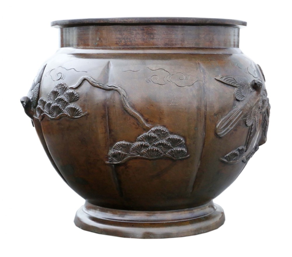 A Japanese Meiji period cast bronze jardiniere featuring a lobed body and high-relief carved decoration depicting birds amongst pine branches. View VII