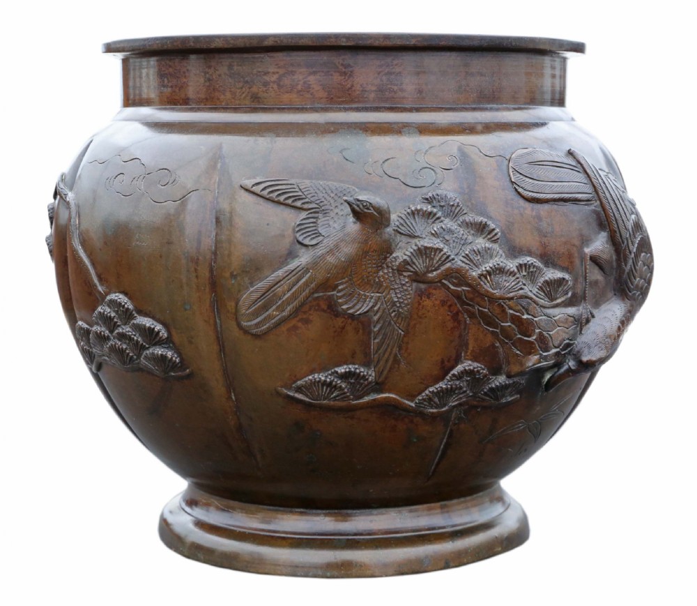 A Japanese Meiji period cast bronze jardiniere featuring a lobed body and high-relief carved decoration depicting birds amongst pine branches. View VIII