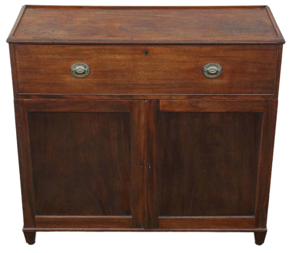 A 19th-century rich mahogany cabinet featuring a single top drawer with oval brass handles above two panelled cupboard doors.