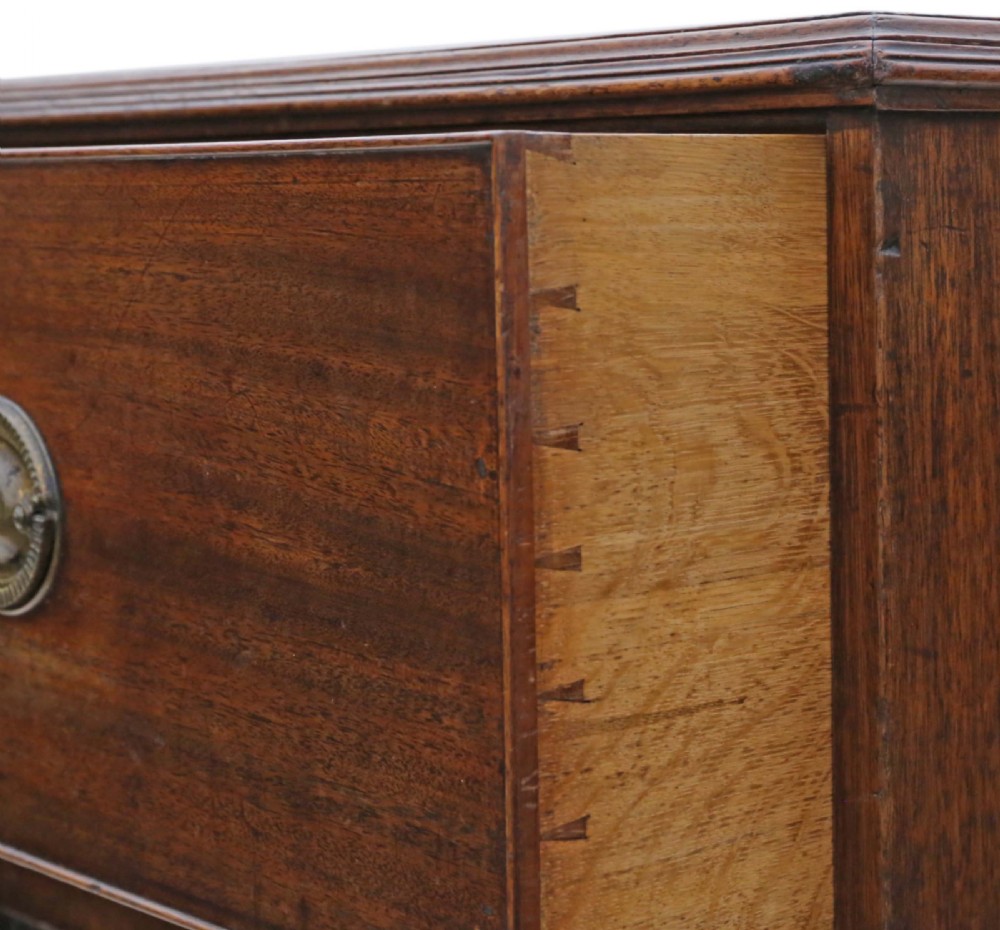 A 19th-century rich mahogany cabinet featuring a single top drawer with oval brass handles above two panelled cupboard doors. View VI