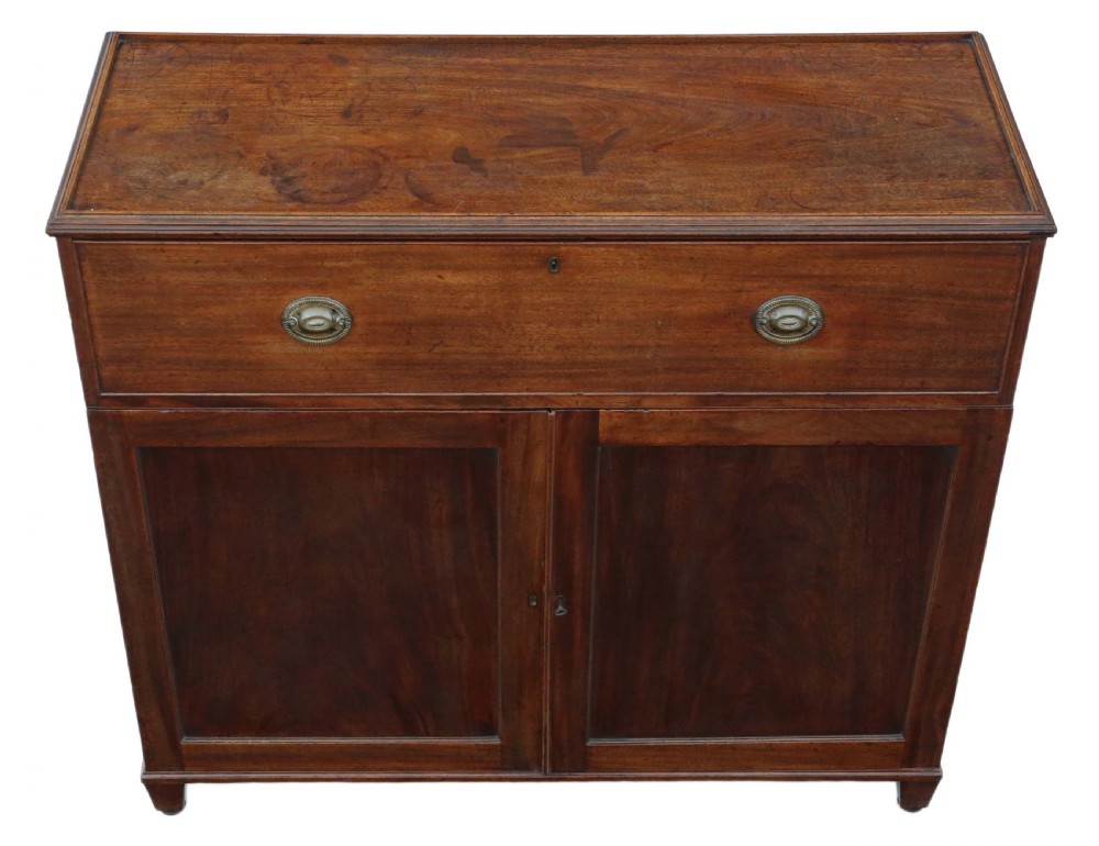 A 19th-century rich mahogany cabinet featuring a single top drawer with oval brass handles above two panelled cupboard doors. View X