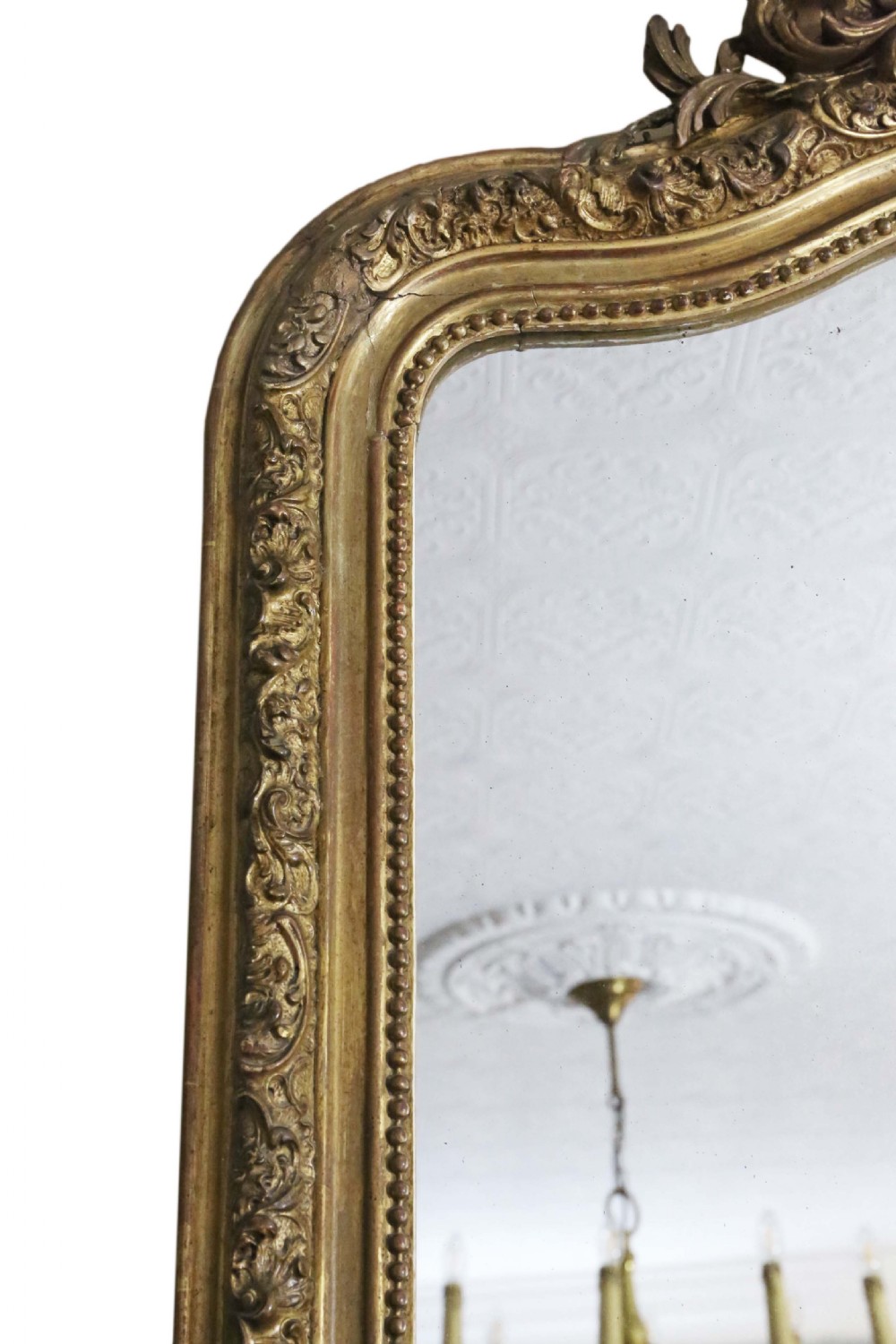 A tall 19th-century arched giltwood overmantel mirror featuring an ornate carved shell crest and decorative moulded frame. View III