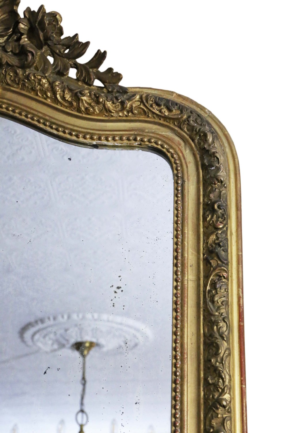 A tall 19th-century arched giltwood overmantel mirror featuring an ornate carved shell crest and decorative moulded frame. View IV