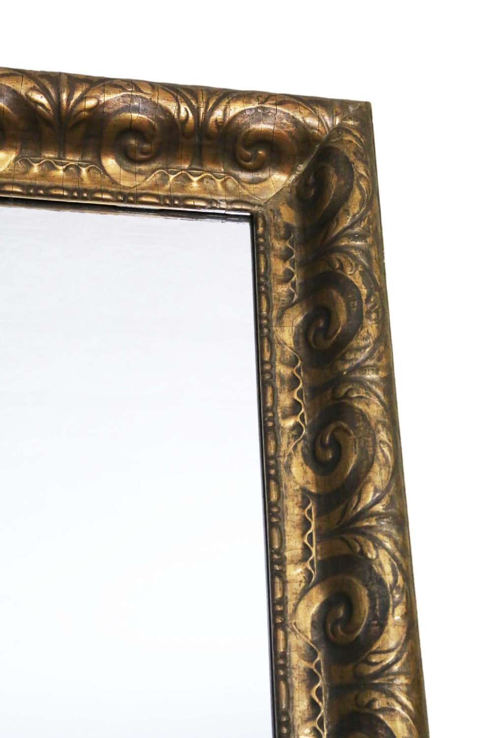 A large rectangular 19th-century overmantel mirror featuring a thick gold giltwood frame carved with continuous scroll motifs. View III