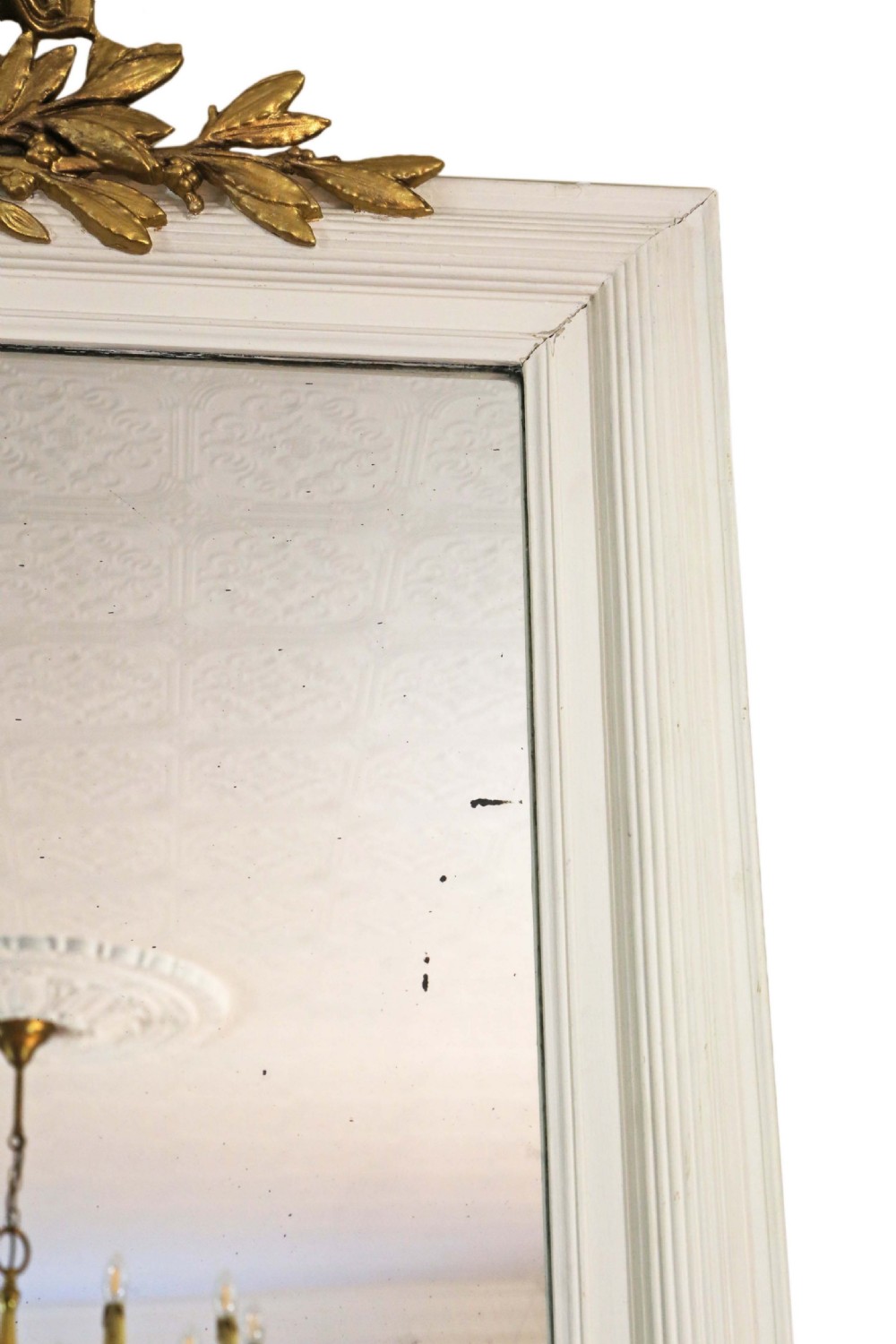 A large 19th-century rectangular wall mirror featuring a painted white frame topped with an ornate gilded crest. View III