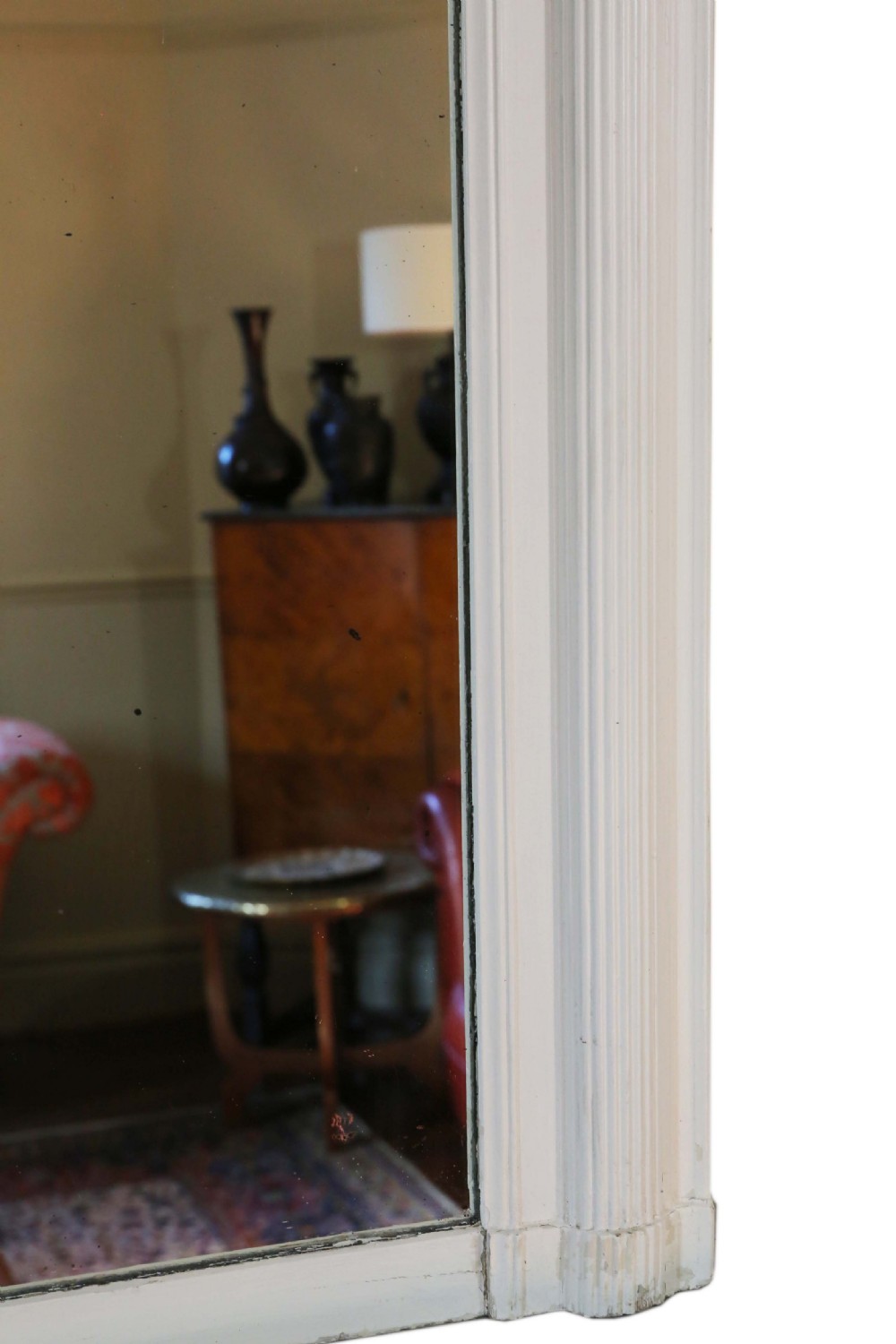 A large 19th-century rectangular wall mirror featuring a painted white frame topped with an ornate gilded crest. View V
