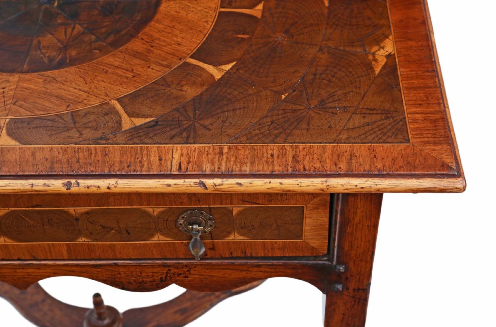 A Queen Anne revival walnut side table featuring a circular oyster veneer top pattern, a single drawer with brass handles, turned legs, and an X-stretcher. View V