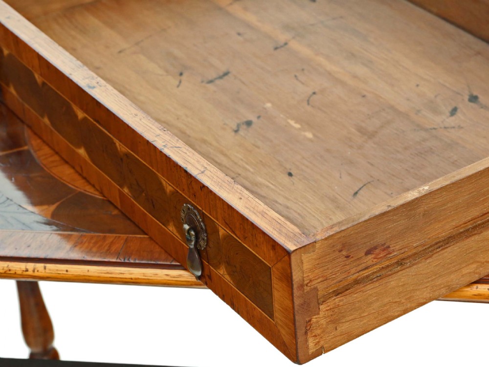 A Queen Anne revival walnut side table featuring a circular oyster veneer top pattern, a single drawer with brass handles, turned legs, and an X-stretcher. View VIII
