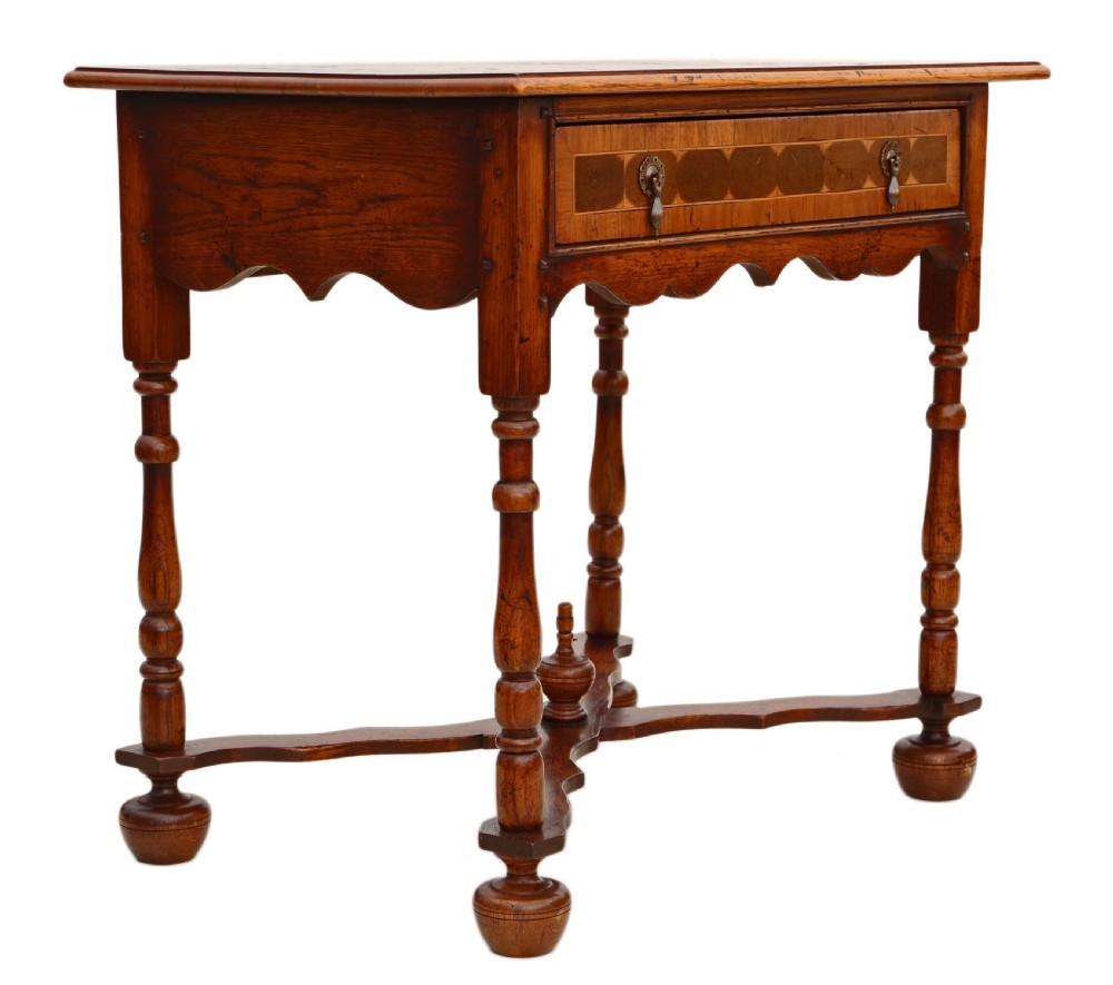 A Queen Anne revival walnut side table featuring a circular oyster veneer top pattern, a single drawer with brass handles, turned legs, and an X-stretcher. View X