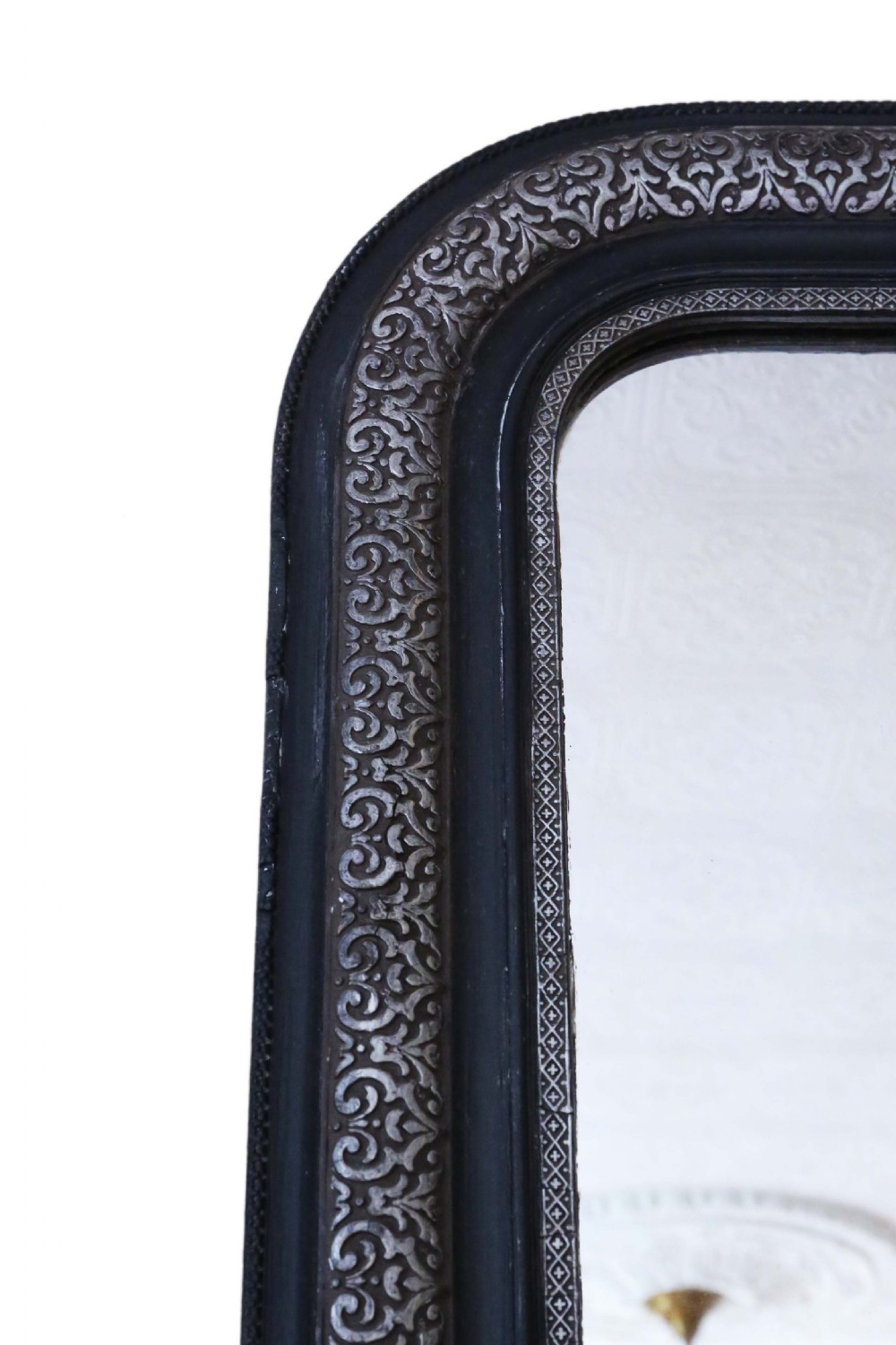 A large late 19th-century rectangular wall mirror featuring rounded top corners, an ebonised outer frame, and an embossed silver gilt inner border. View II
