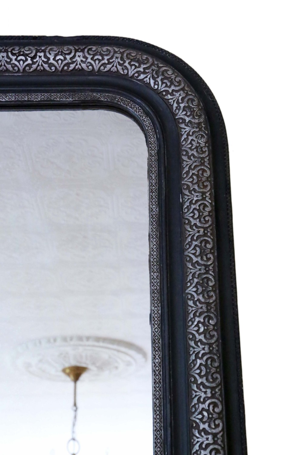 A large late 19th-century rectangular wall mirror featuring rounded top corners, an ebonised outer frame, and an embossed silver gilt inner border. View IV