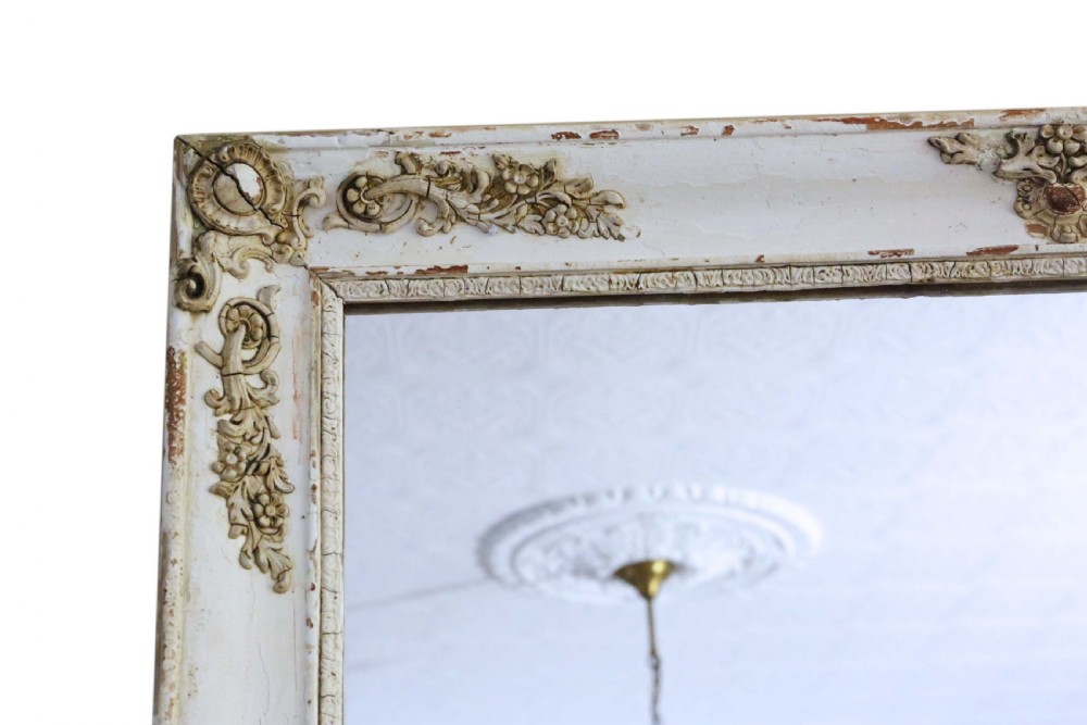 A large nineteenth-century rectangular French overmantle mirror with a cream-painted frame featuring moulded floral scrollwork details and a distressed finish. View II