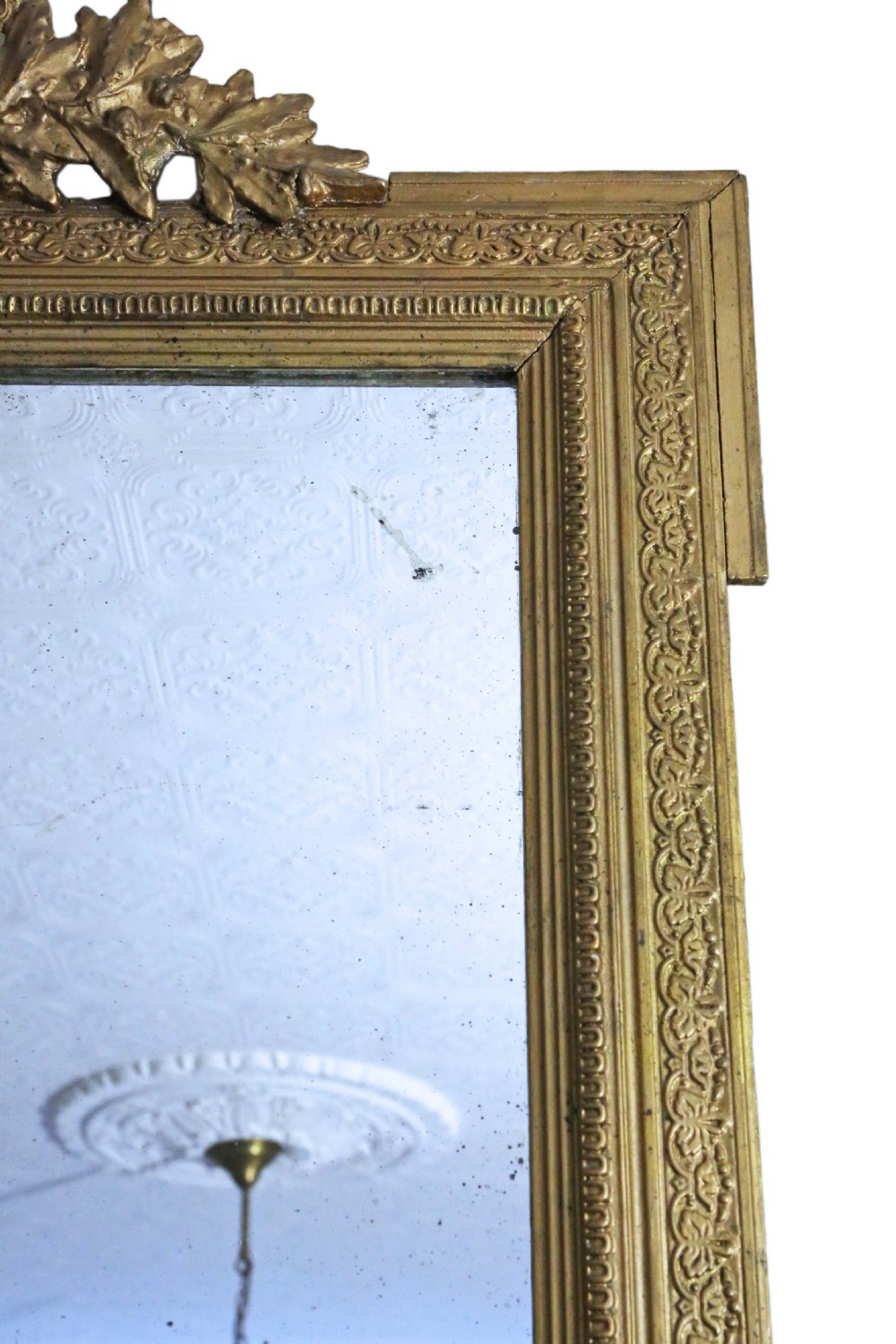 A tall 19th-century rectangular giltwood overmantel mirror featuring an ornate acanthus leaf crest and decorative moulded frame. View VI