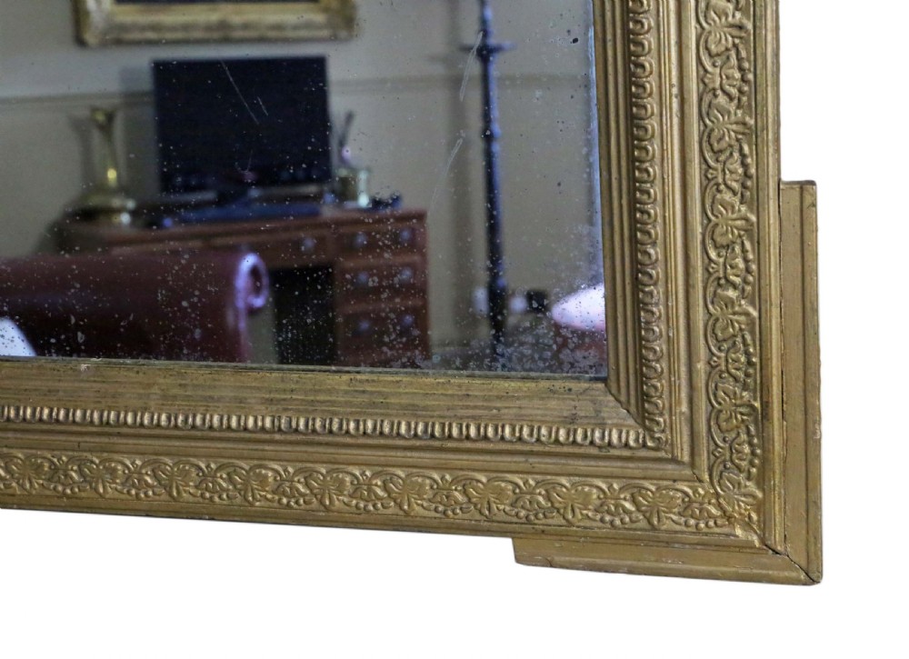 A tall 19th-century rectangular giltwood overmantel mirror featuring an ornate acanthus leaf crest and decorative moulded frame. View VII