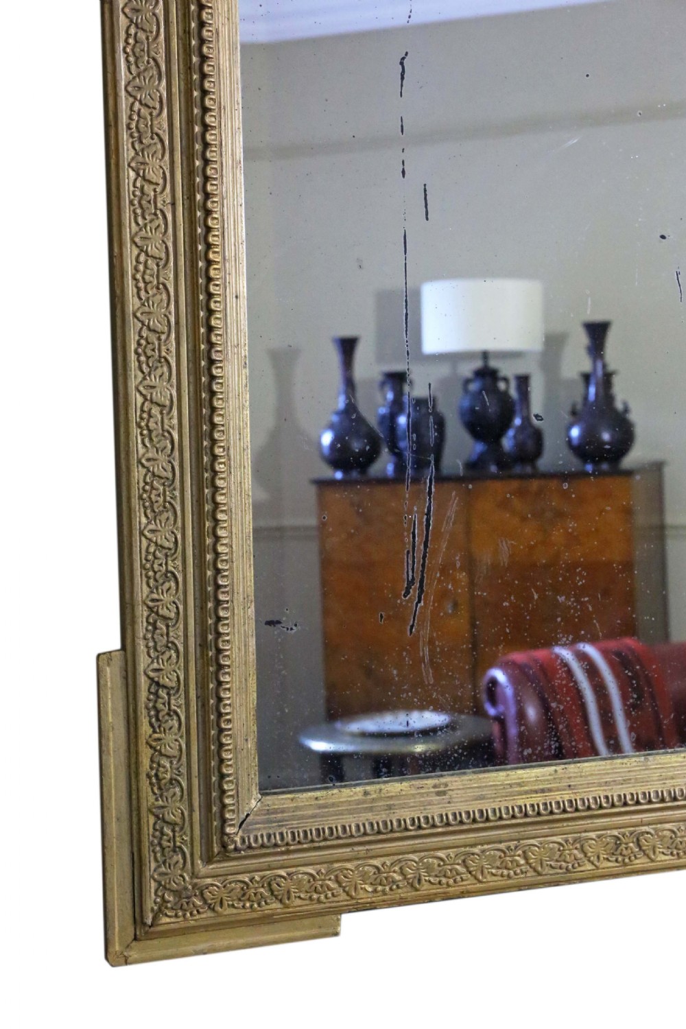 A tall 19th-century rectangular giltwood overmantel mirror featuring an ornate acanthus leaf crest and decorative moulded frame. View IX