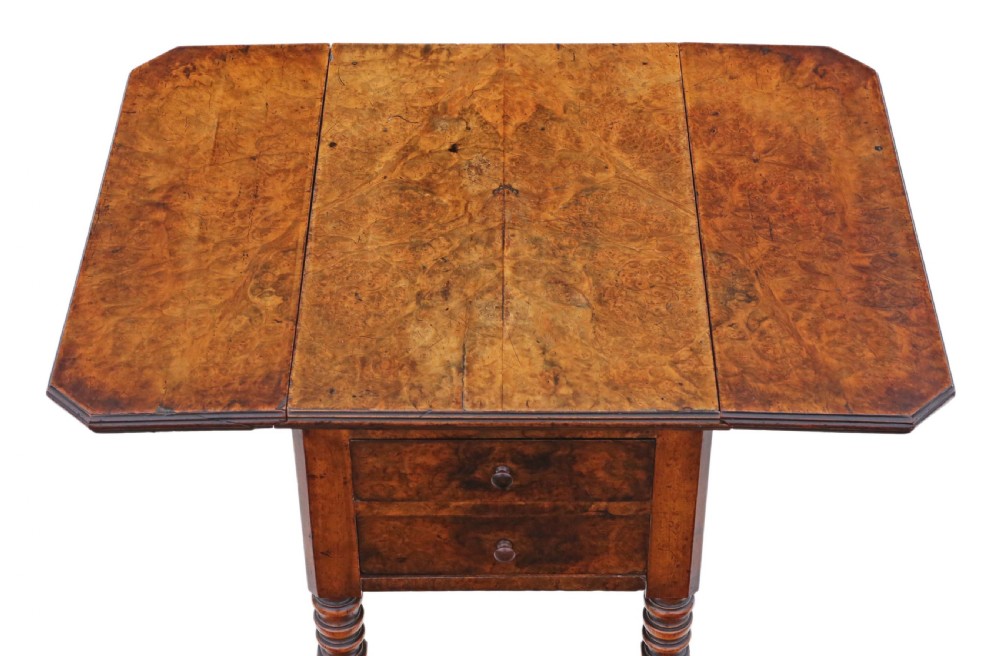 A Victorian burr walnut drop-leaf work table featuring two drawers, turned legs, and brass castors against a plain background. View III