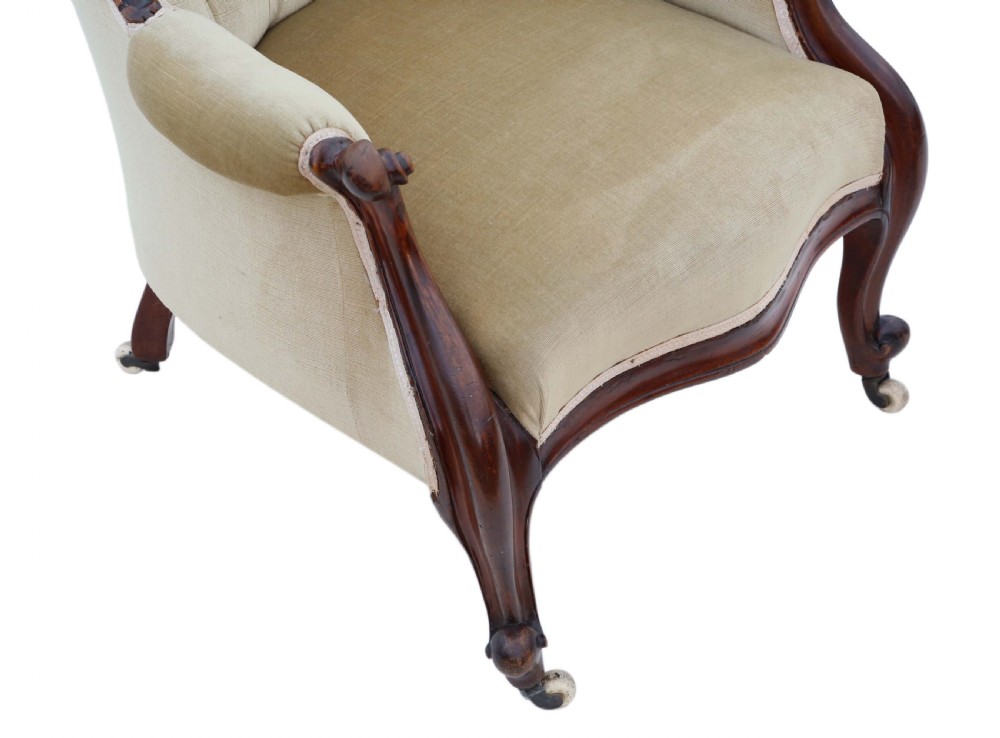 A Victorian mahogany spoon-back armchair featuring deep-buttoned beige velvet upholstery and cabriole front legs with castors. View VI