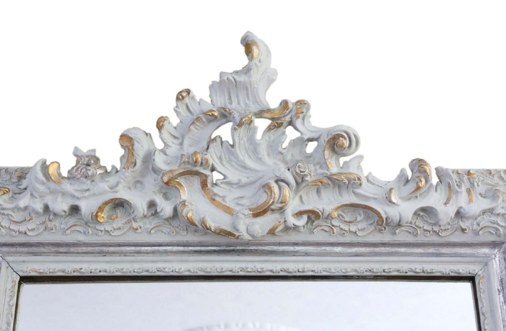 A large rectangular light grey painted frame featuring a gilded inner border and an ornate carved rococo crest at the top. View II