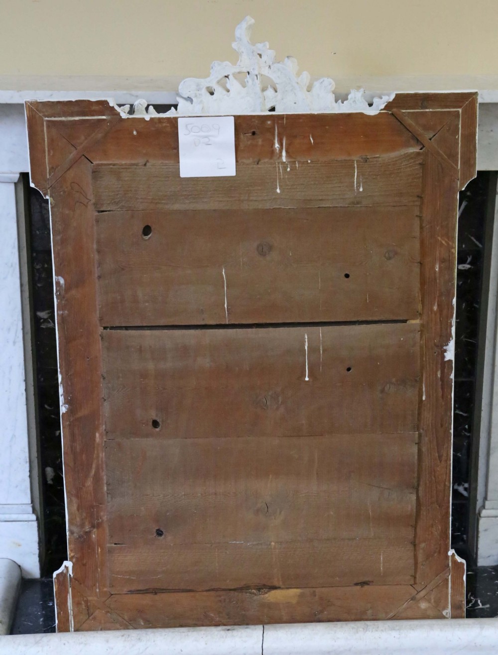 A large rectangular light grey painted frame featuring a gilded inner border and an ornate carved rococo crest at the top. View VII