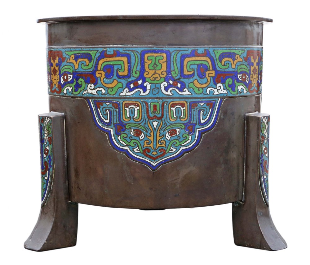 A large dark bronze planter decorated with colourful champleve enamel scroll patterns, supported by four cast feet. View II