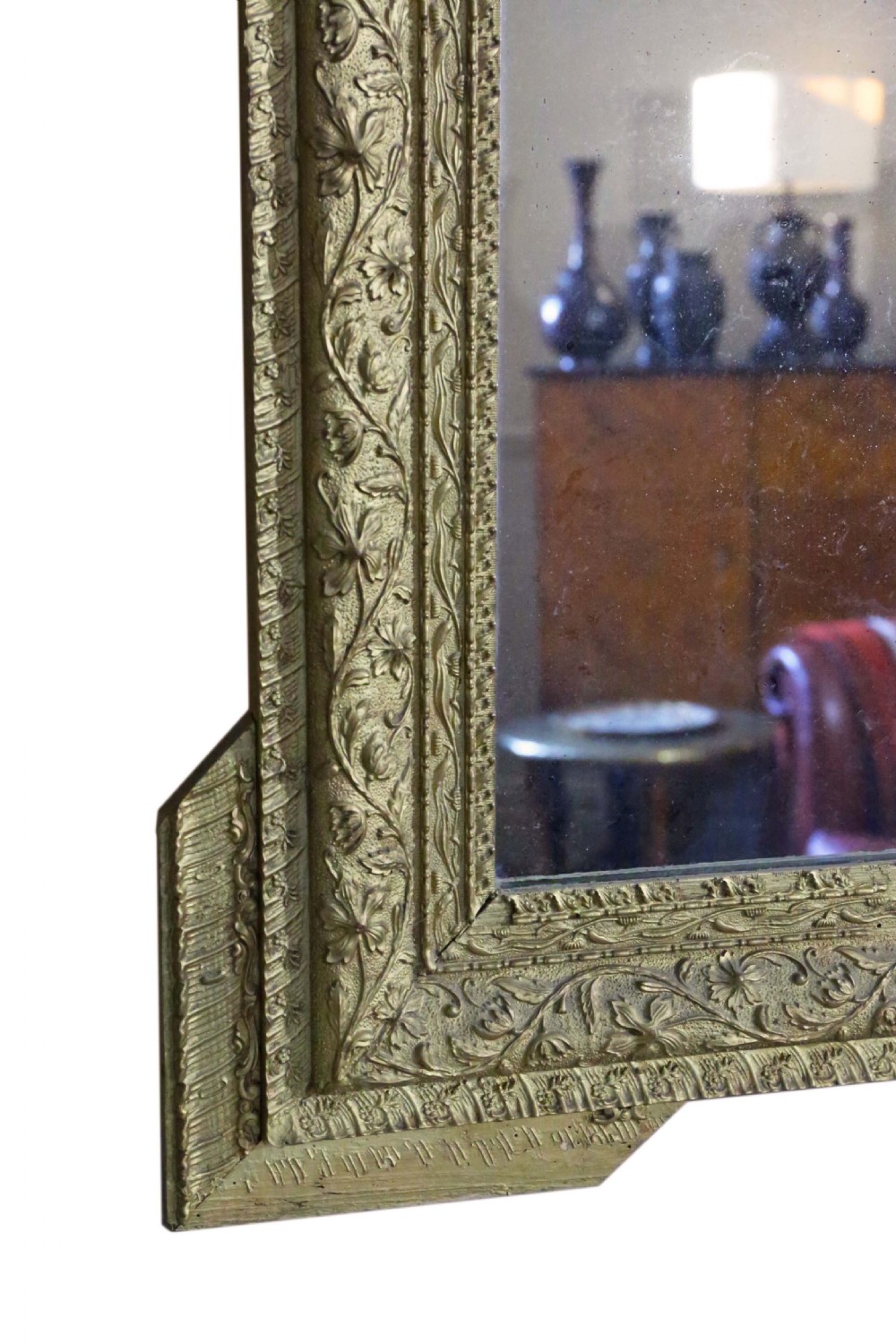 A large 19th-century rectangular giltwood wall mirror with an ornate crest depicting cherubs and an urn above floral moulding. View V