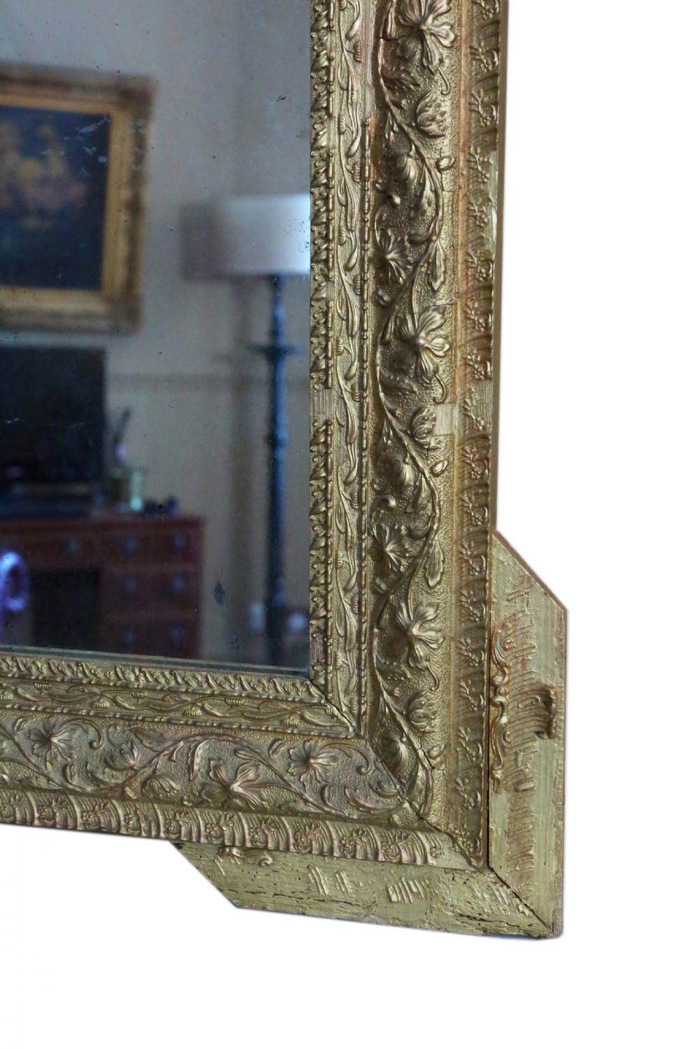 A large 19th-century rectangular giltwood wall mirror with an ornate crest depicting cherubs and an urn above floral moulding. View VI