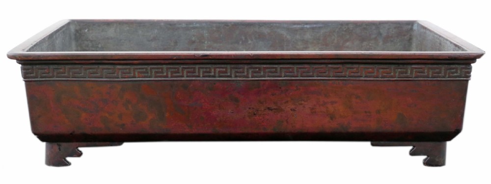 A rectangular dark bronze Japanese suiban planter featuring a key fret relief pattern around the upper border and four corner bracket feet. View III