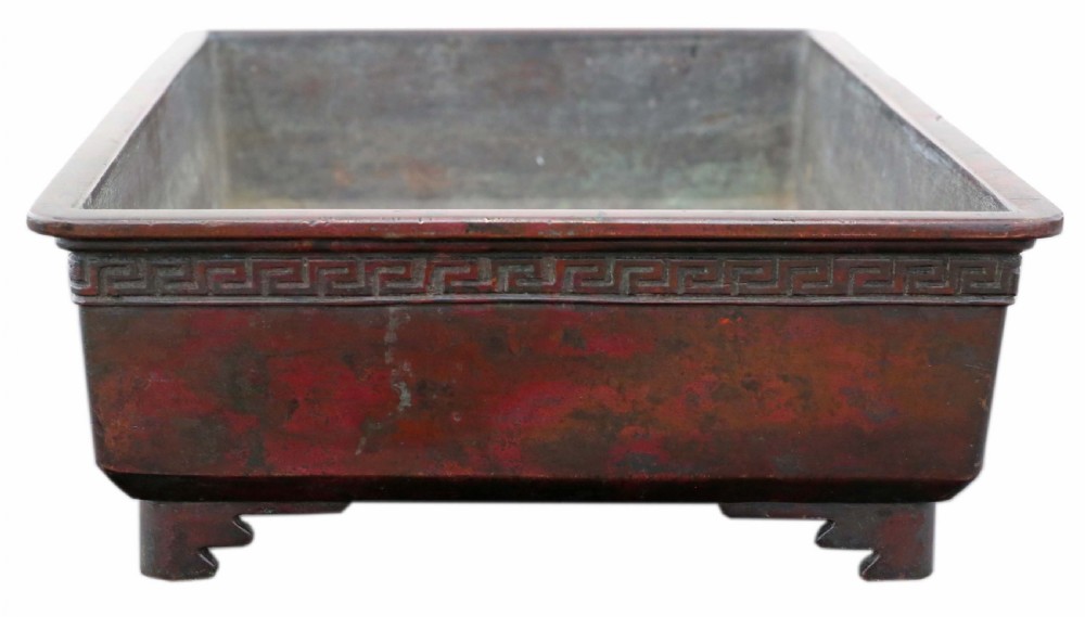 A rectangular dark bronze Japanese suiban planter featuring a key fret relief pattern around the upper border and four corner bracket feet. View IV