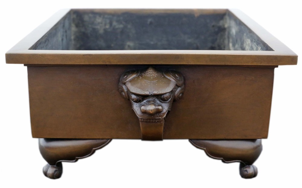 A rectangular Japanese bronze suiban planter featuring incised foliage motifs on the front panel and raised corner feet. View II