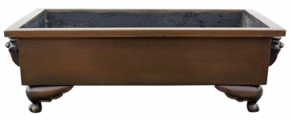 A rectangular Japanese bronze suiban planter featuring incised foliage motifs on the front panel and raised corner feet. View III