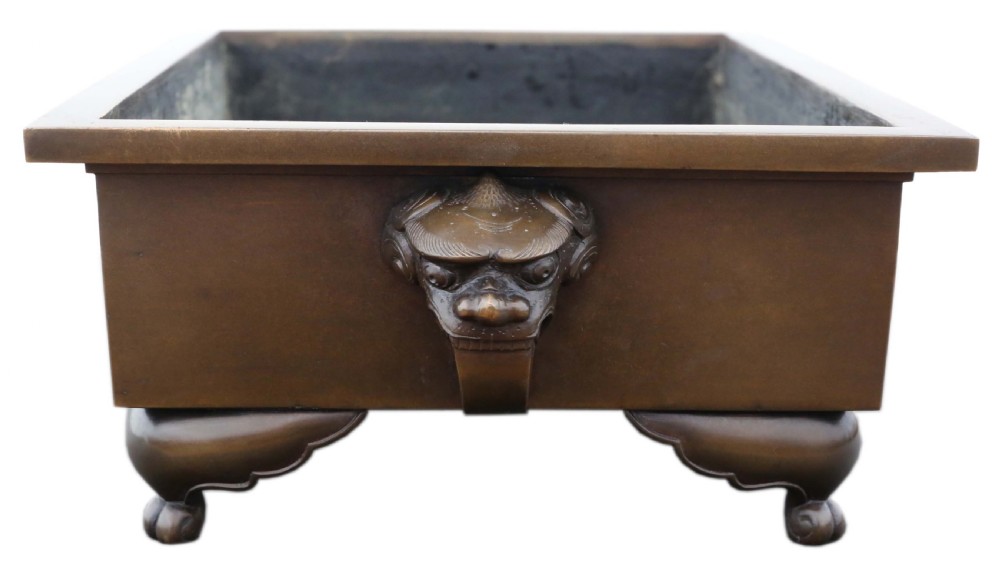 A rectangular Japanese bronze suiban planter featuring incised foliage motifs on the front panel and raised corner feet. View IV